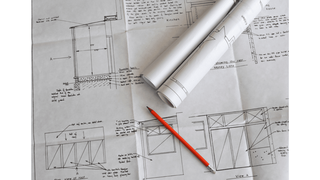 A pencil and some paper on top of construction plans.